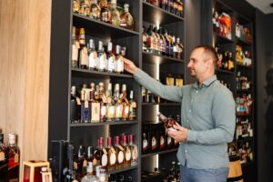 liquor-store-owner-stocking-shelves
