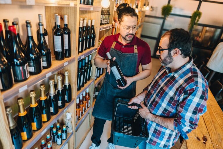shop-clerk-helping-a-customer-choose-wine